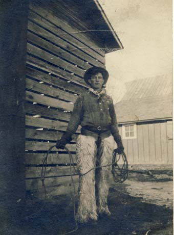Cowboy in chaps and holding rope postcard, 1900s