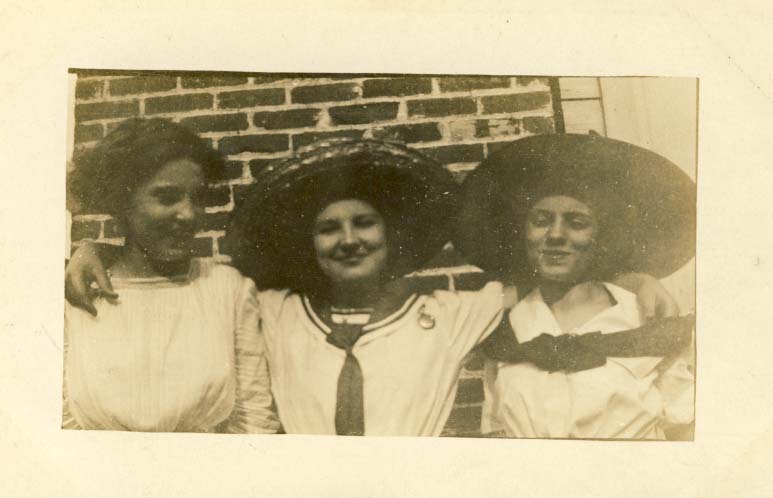 Three women, two in hats postcard