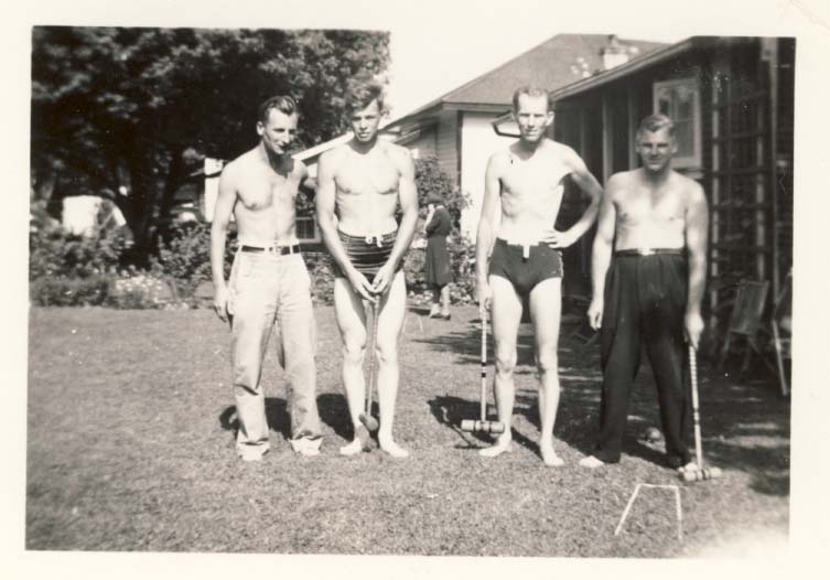 4 shirtless men playing in back yard photograph