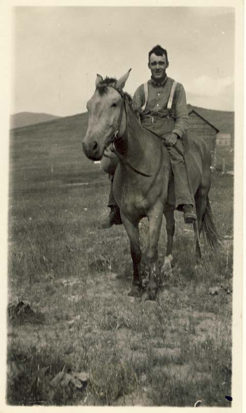 Man wearing suspenders, without hat, on his horse postcard