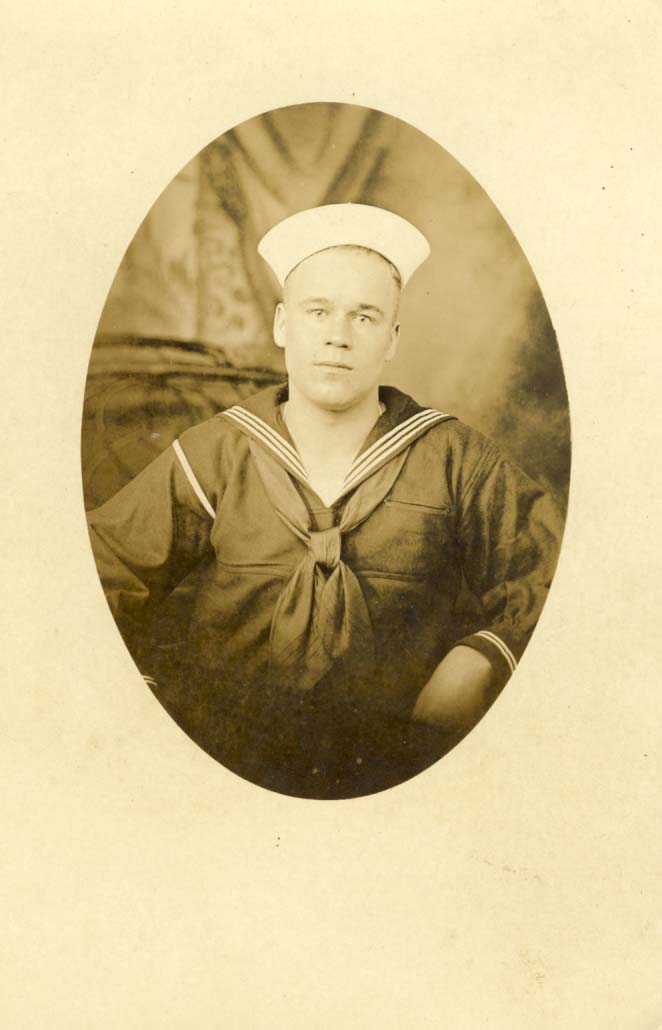 Sailor, American, with white cap in oval frame photograph